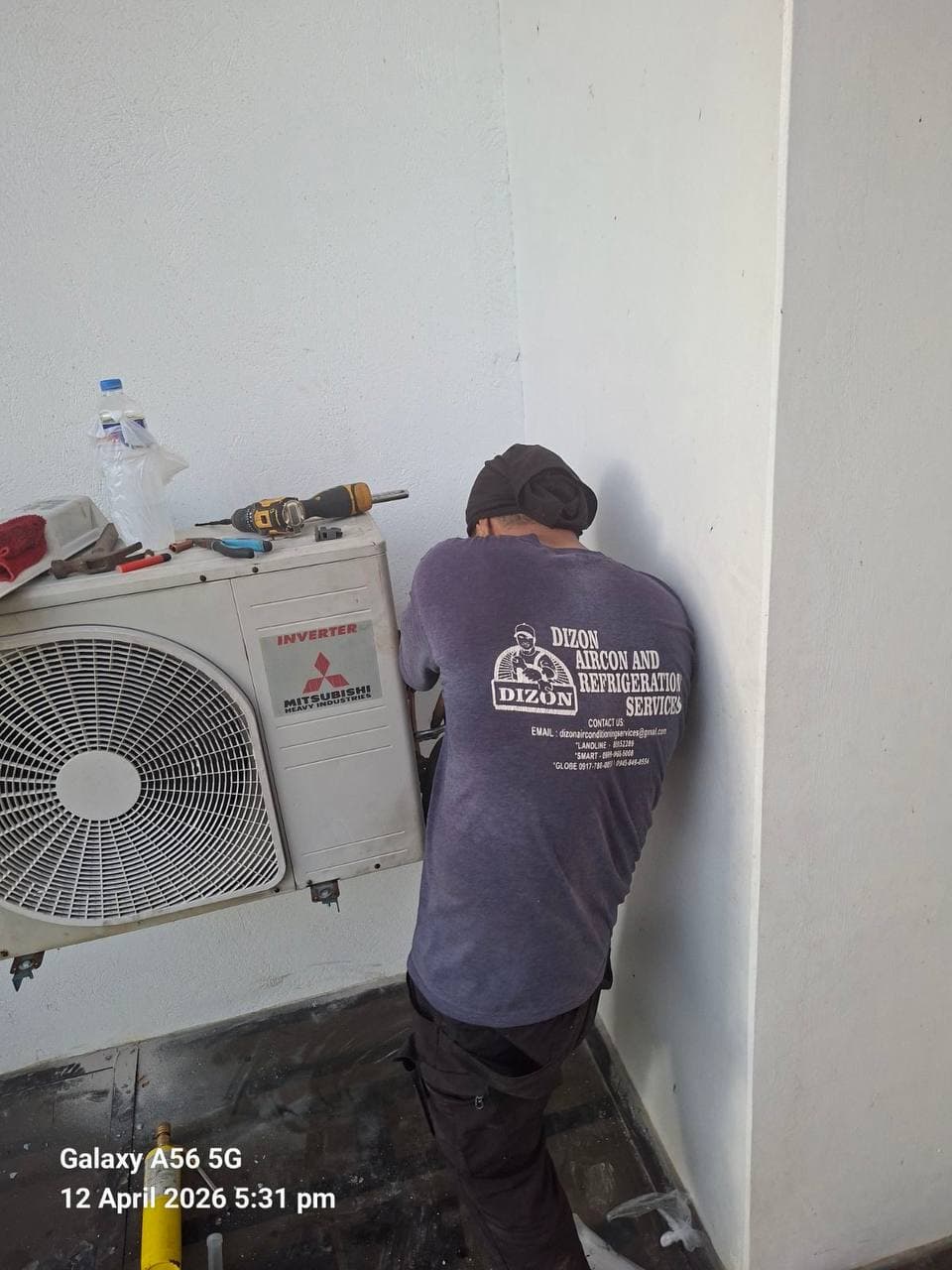 Dizon technician working on an inverter outdoor unit